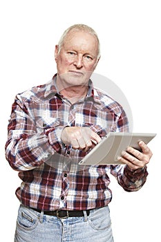 Senior man using tablet computer looking confused