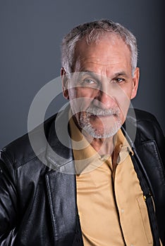 Senior man very attentive with his eyes focusing on camera