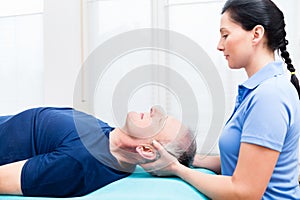 Senior man visiting physiotherapist for massage