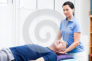 Senior man visiting physiotherapist for massage