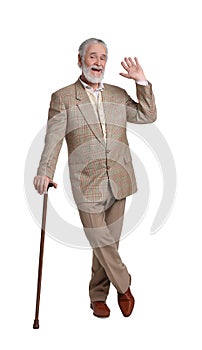 Senior man with walking cane waving on white background