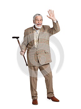 Senior man with walking cane waving on white background