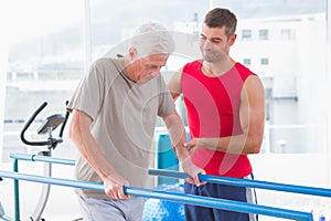 Senior man walking with coach help