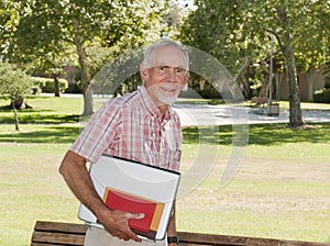 Senior man walking to class on campus