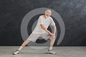 Senior man warmup stretching training indoors