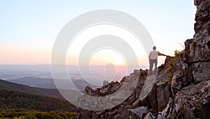 Senior man watches sunrise over blue ridge