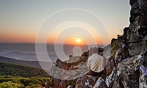 Senior man watches sunrise over blue ridge