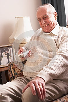 Senior Man Watching TV At Home