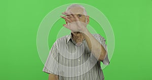 Senior man waving hands to camera. Handsome old man on chroma key background