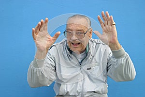 Senior man waving his hands