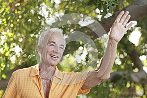 Senior man waving and smiling