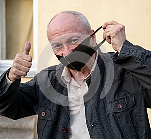 Senior man wearing protective mask outdoors