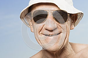 Senior man wearing sunhat and sunglasses