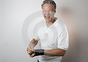 Senior Man wearing a wrist brace on his left hand and wrist