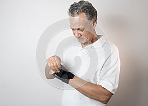 Senior Man wearing a wrist brace on his left hand and wrist