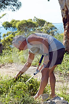 Senior man weeding photo
