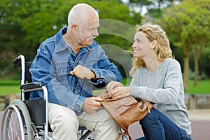 senior man in wheelchair with adult daughter