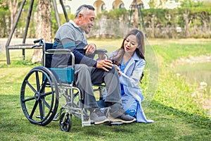 Senior man on wheelchair with doctor