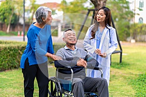 Senior man on wheelchair with doctor and wife