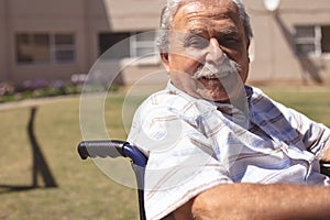 Senior man in wheelchair smiling at the camera