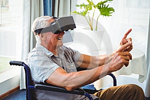 Senior man in a wheelchair using a virtual reality device