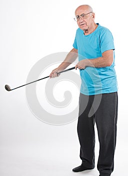 Senior man on white background plays golf