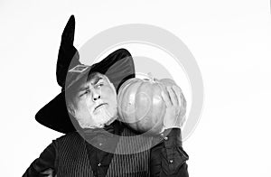 Senior man white beard celebrate Halloween with pumpkin. Magic concept. Experienced and wise. Halloween tradition