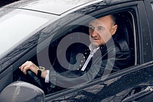 Senior man at winter time in car, retired people lifestyle