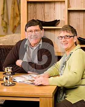 Senior man and woman couple looking at brochure