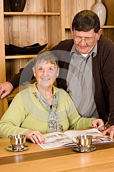 Senior man and woman couple looking at brochure