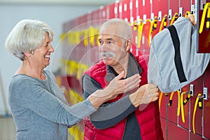 senior man and woman in fitness club locker room