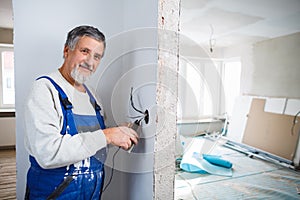 Senior man working on the electrical installations