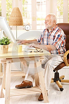 Senior man working in his study