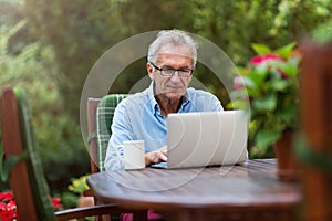 Senior man working on laptop