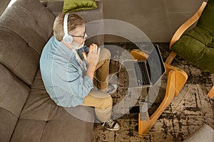Senior man working with laptop at home - concept of home studying