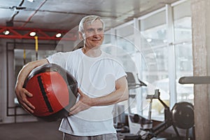 Senior man working out at the gym