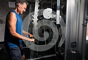 Senior Man working out in the Gym