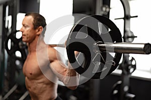 Senior man working out at the gym doing squats