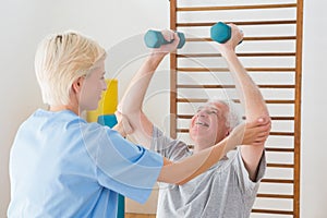 Senior man working out with his therapist