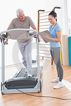 Senior man working out with his trainer