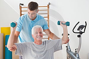 Senior man working out with his trainer