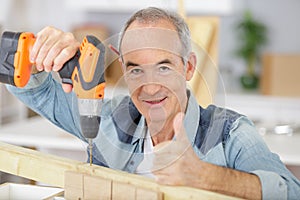 Senior man working on tools at home