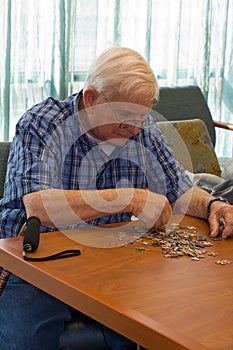 Senior man works on puzzle