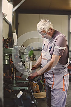 Senior man working in workshop.