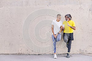 senior man and young woman talking and using phone