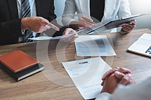 Senior manager HR reading a resume during a job interview employee young man meeting Applicant and recruitment