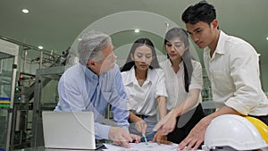 Senior Manager and industrial engineers team checking on production plans in a factory.