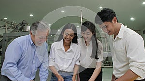 Senior Manager and industrial engineers team checking on production plans in a factory.