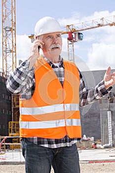 Senior manual worker calling on phone