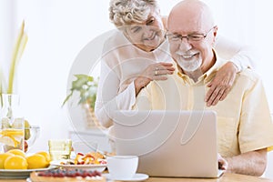 Senior marriage looking at laptop